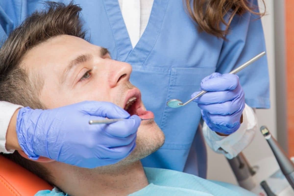 Dentist performing a routine dental checkup on a patient in a modern clinic.