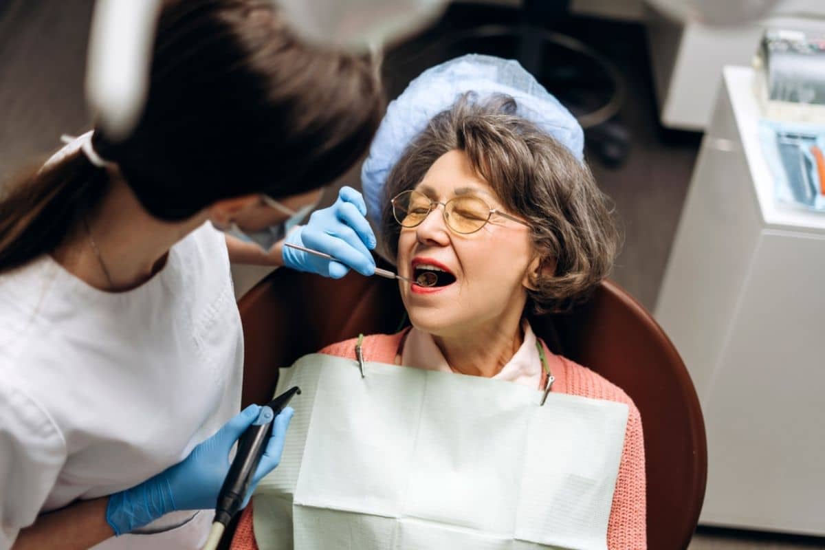 general dentist performing a routine oral examination General dentist performing a routine oral examination.