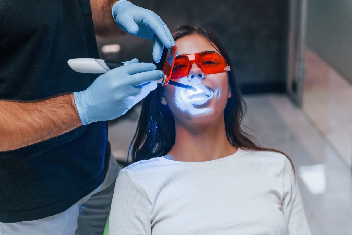 teeth whitening treatment Dentist performing professional teeth whitening treatment.