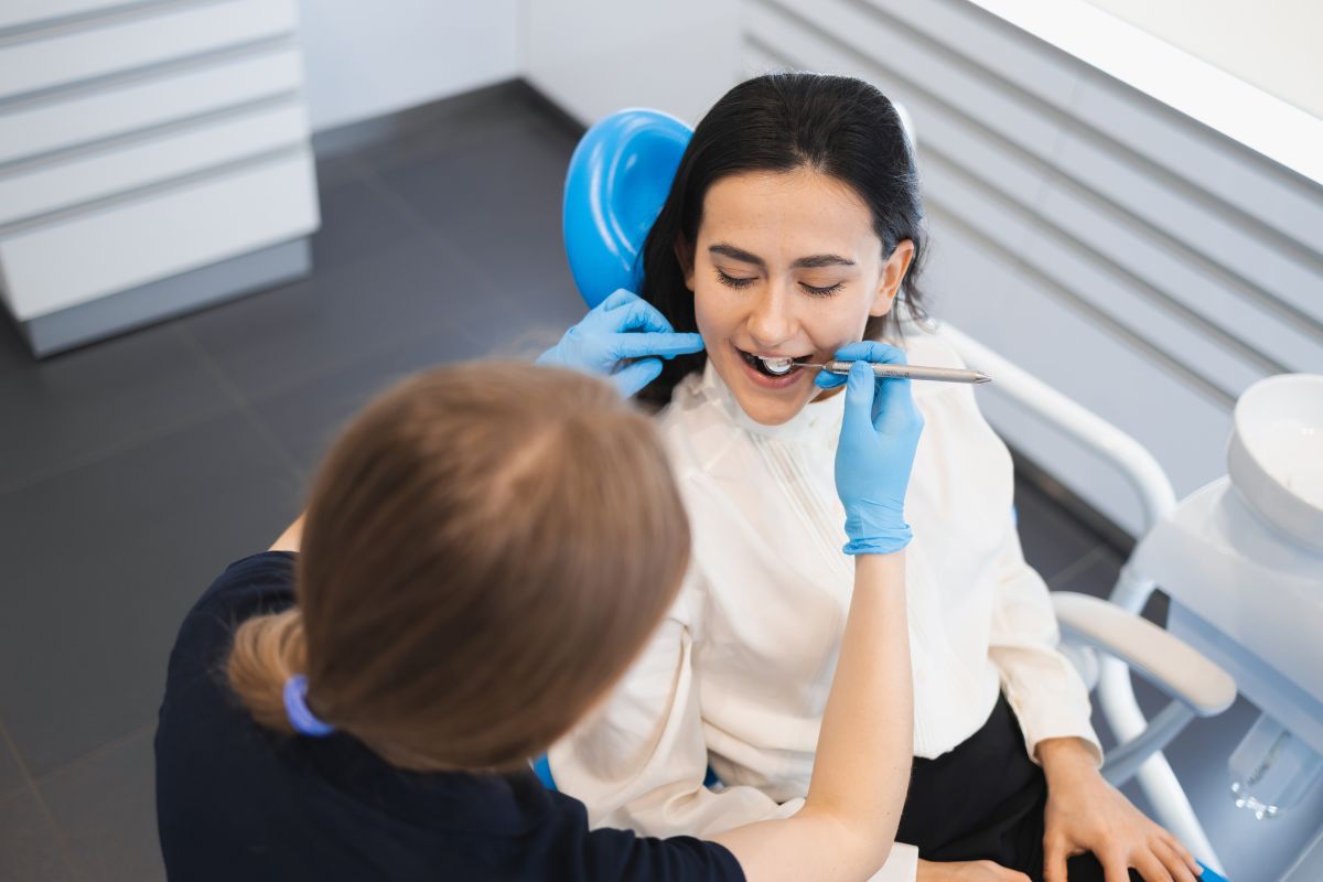 Dentist performing a cosmetic dental treatment to enhance smile and facial balance.