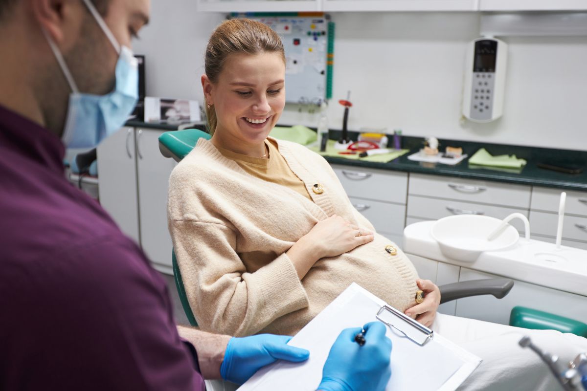 Pregnant woman receiving dental checkup.