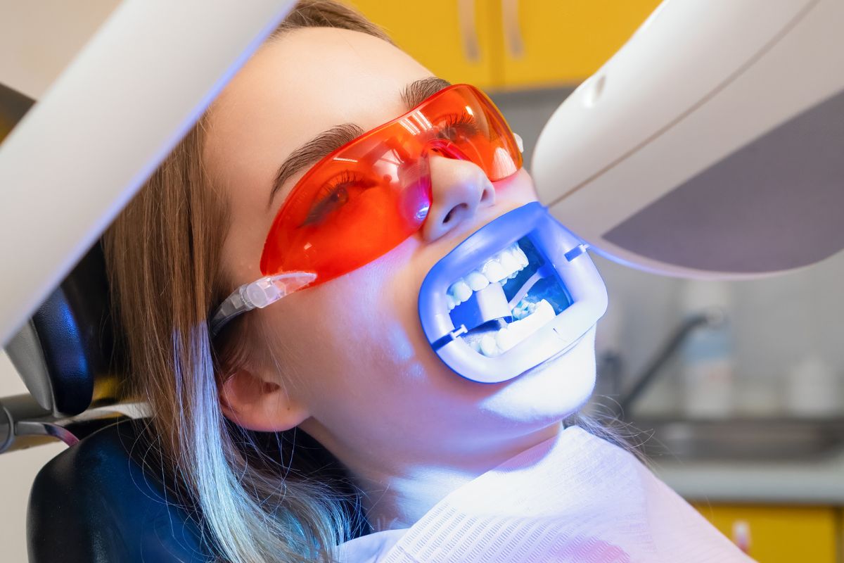 teeth whitening Patient receiving professional LED teeth whitening treatment at a dental office.