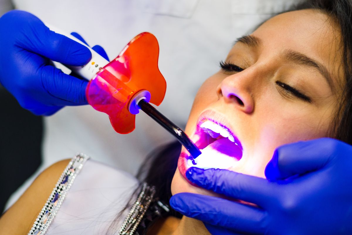 Patient receiving LED teeth whitening treatment.